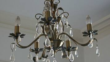 Un lustre à plusieurs bras, orné de décorations en cristal.