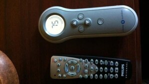 Two remote controls on a wooden surface. - Ashford Motel (Ashford)
