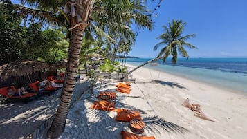 On the beach, white sand, sun-loungers, beach umbrellas