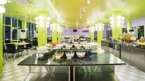 A brightly lit buffet area with multiple food stations and seating arrangements. - Bella Express (Pattaya)