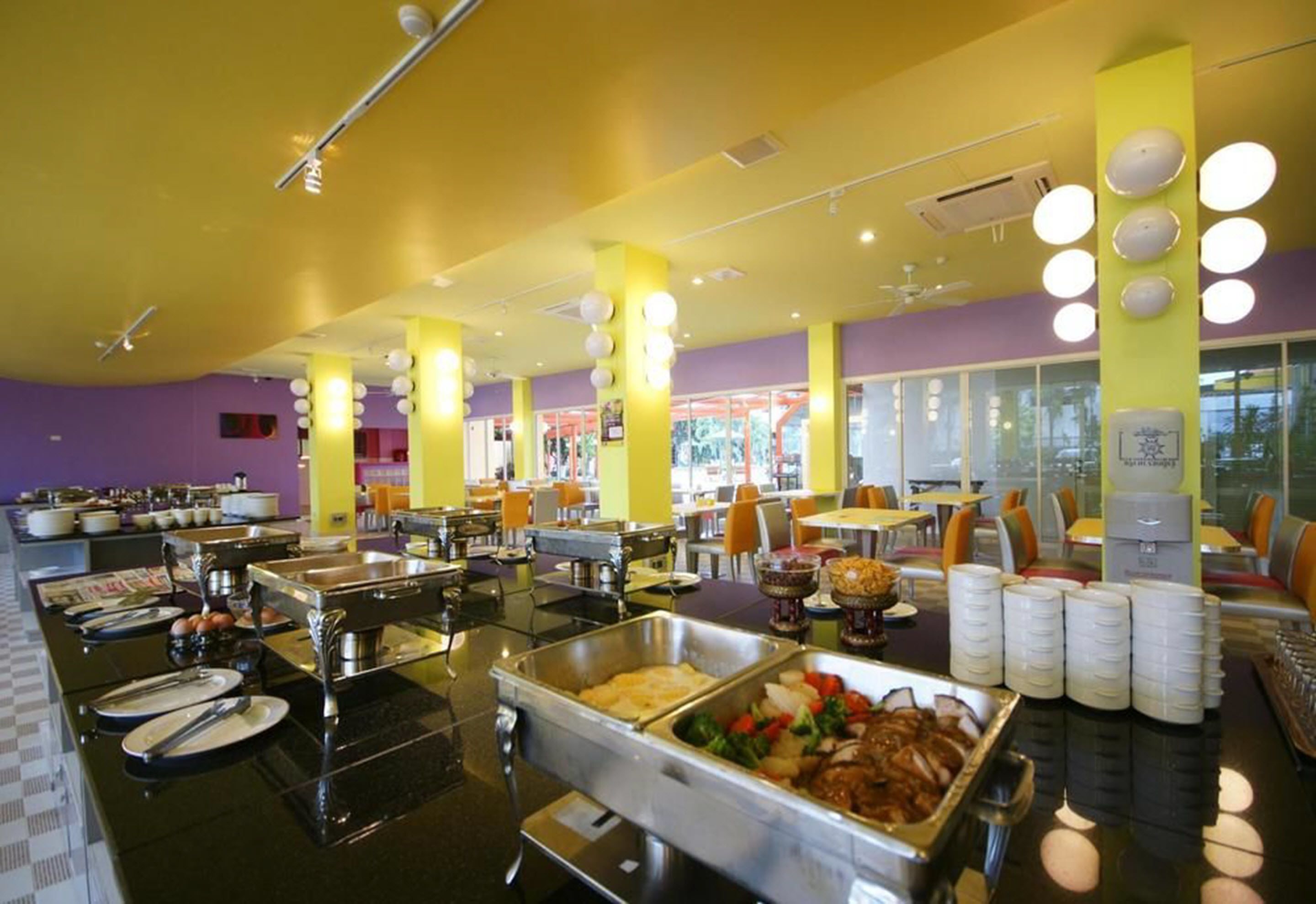 A buffet area with various food stations and seating arrangements.