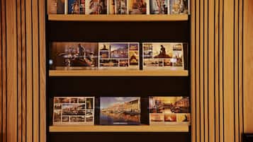 A wall with three shelves displaying framed photographs of Copenhagen.