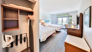 A hotel room with a wooden shelf, ironing board, and a bed with a white comforter. - Hampton Inn & Suites Seattle/Kent,WA (Kent)
