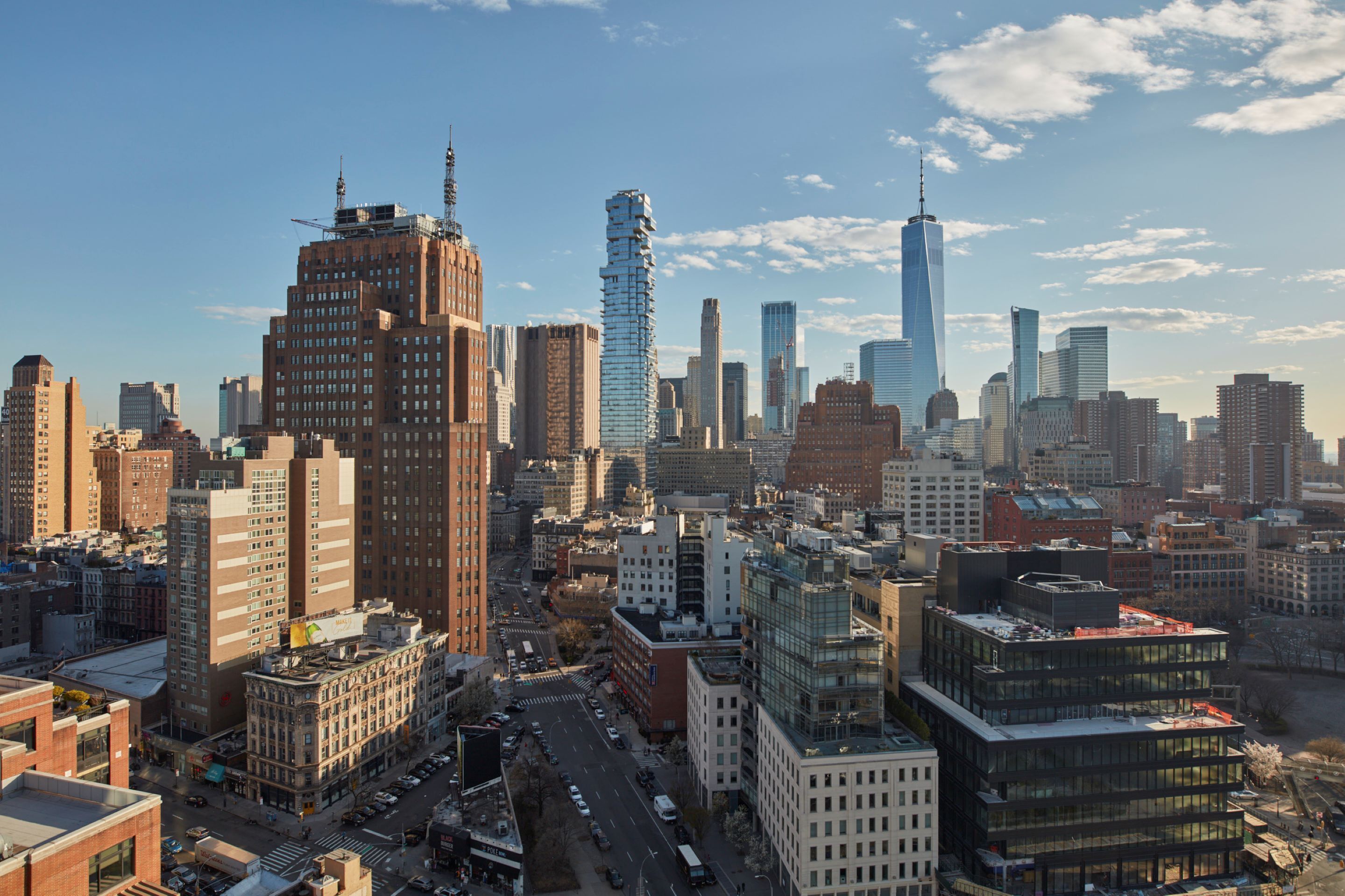 A cityscape with various buildings, including a prominent skyscraper with a unique twisted design.