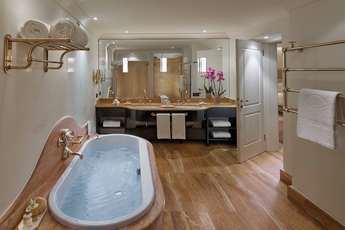 combined shower/bathtub, designer toiletries, hair dryer, bathrobes