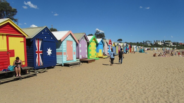 A row of colorful beach huts along a sandy beach. - Brighton Serviced Apartments (Brighton)