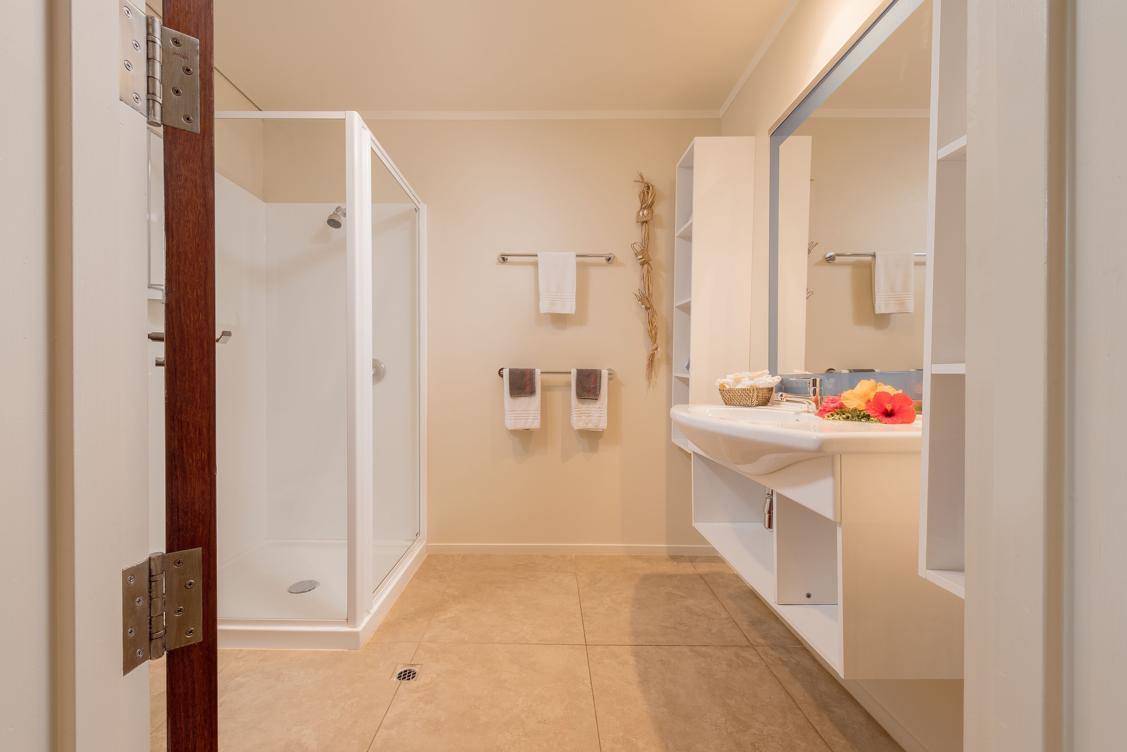A modern bathroom with a shower, toilet, and sink.
