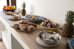 A breakfast buffet with various pastries, fruits, and condiments. - Cabrera House (Pozzallo)