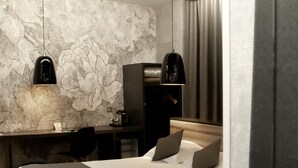 A modern hotel room with a neatly made bed, a desk with a computer, and a large window with curtains. - Hôtel Nota Bene (Montceau-les-Mines)