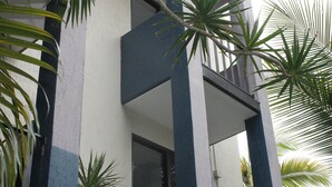 A building with a balcony and a window.