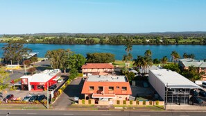 A coastal town with a prominent red building, a Mercedes-Benz dealership, and a view of the lake.
