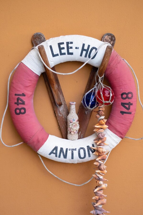 A life preserver with the text 'LEE-HO ANTON' and numbers '148' on it.