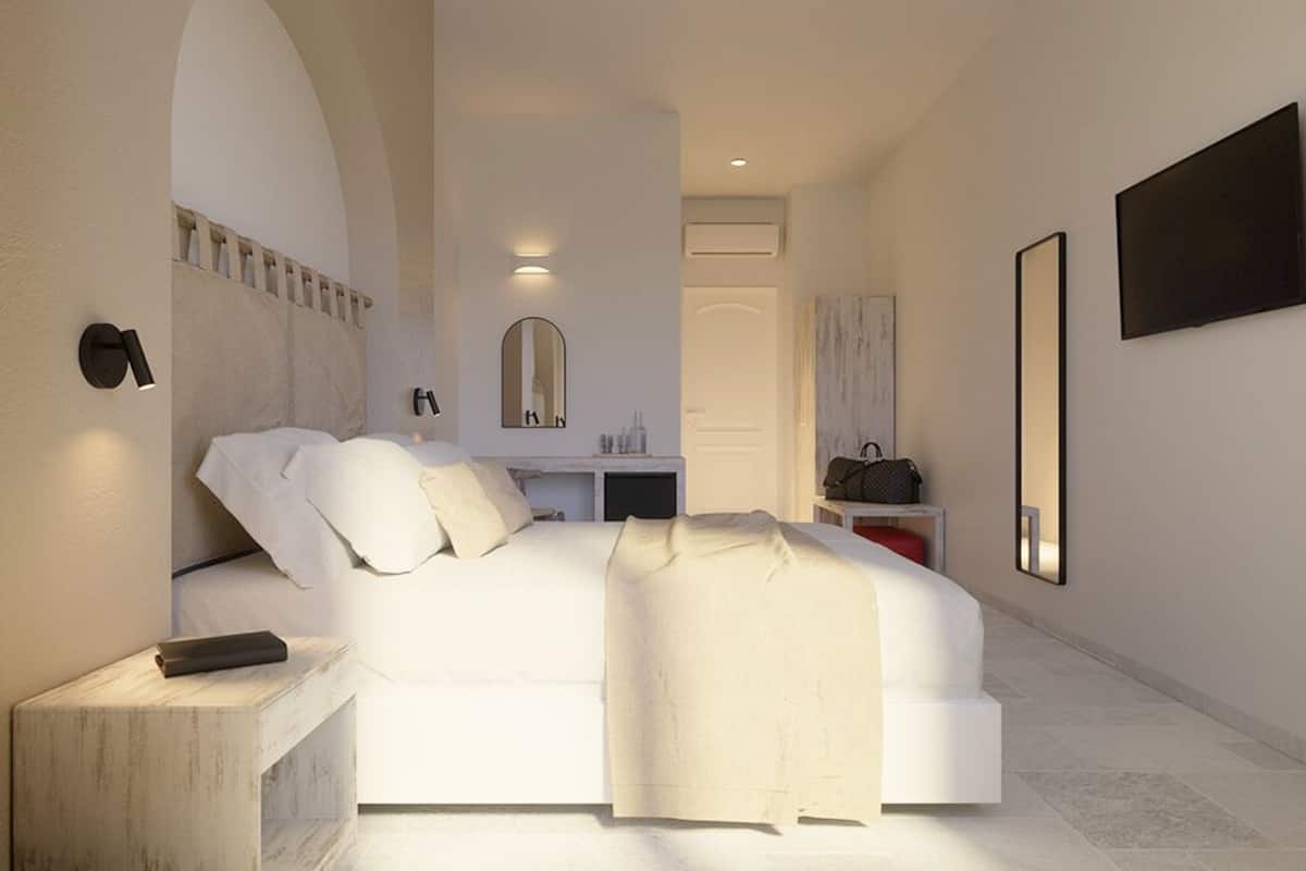 A modern bedroom with a bed, bedside tables, a mirror, and a wardrobe.
