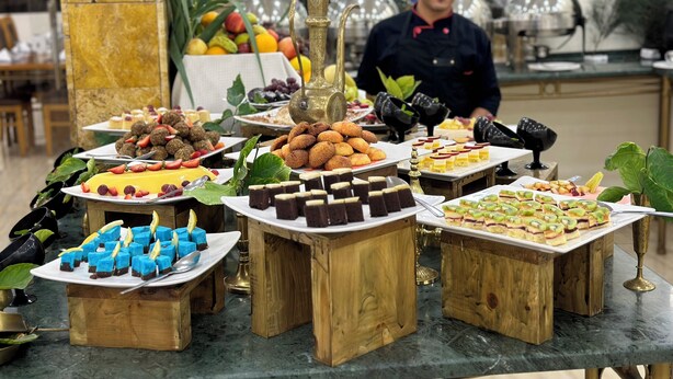 A buffet with various desserts and fruits. - Sharah Mountains Hotel (Wadi Musa)