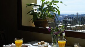 A table set for breakfast with a view of the mountains.