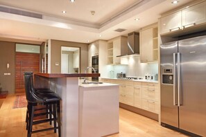 Three-Bedroom Exclusive Penthouse  | Private kitchen | Full-size fridge, microwave, oven, stovetop