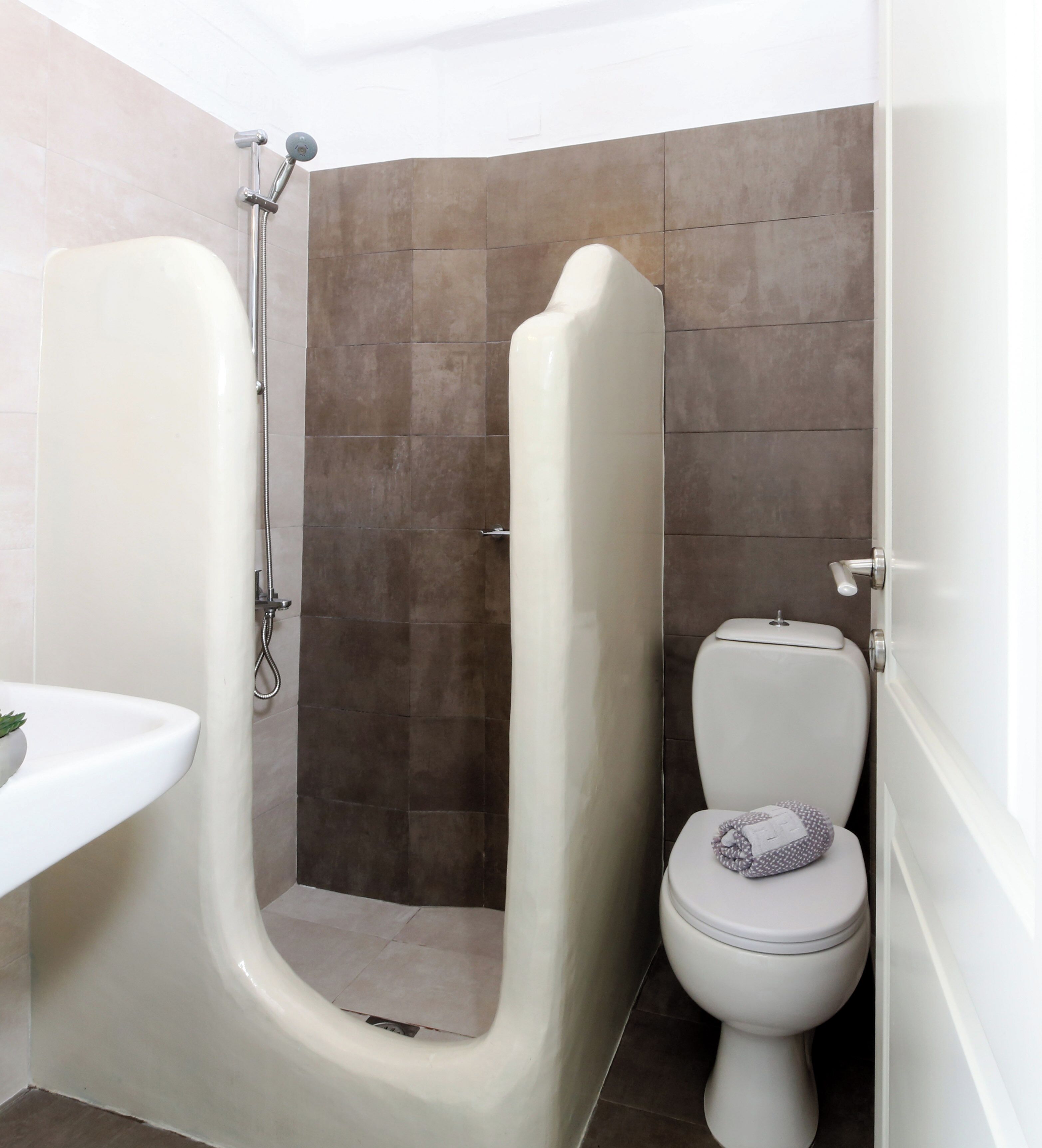 A bathroom with a shower, toilet, and sink.