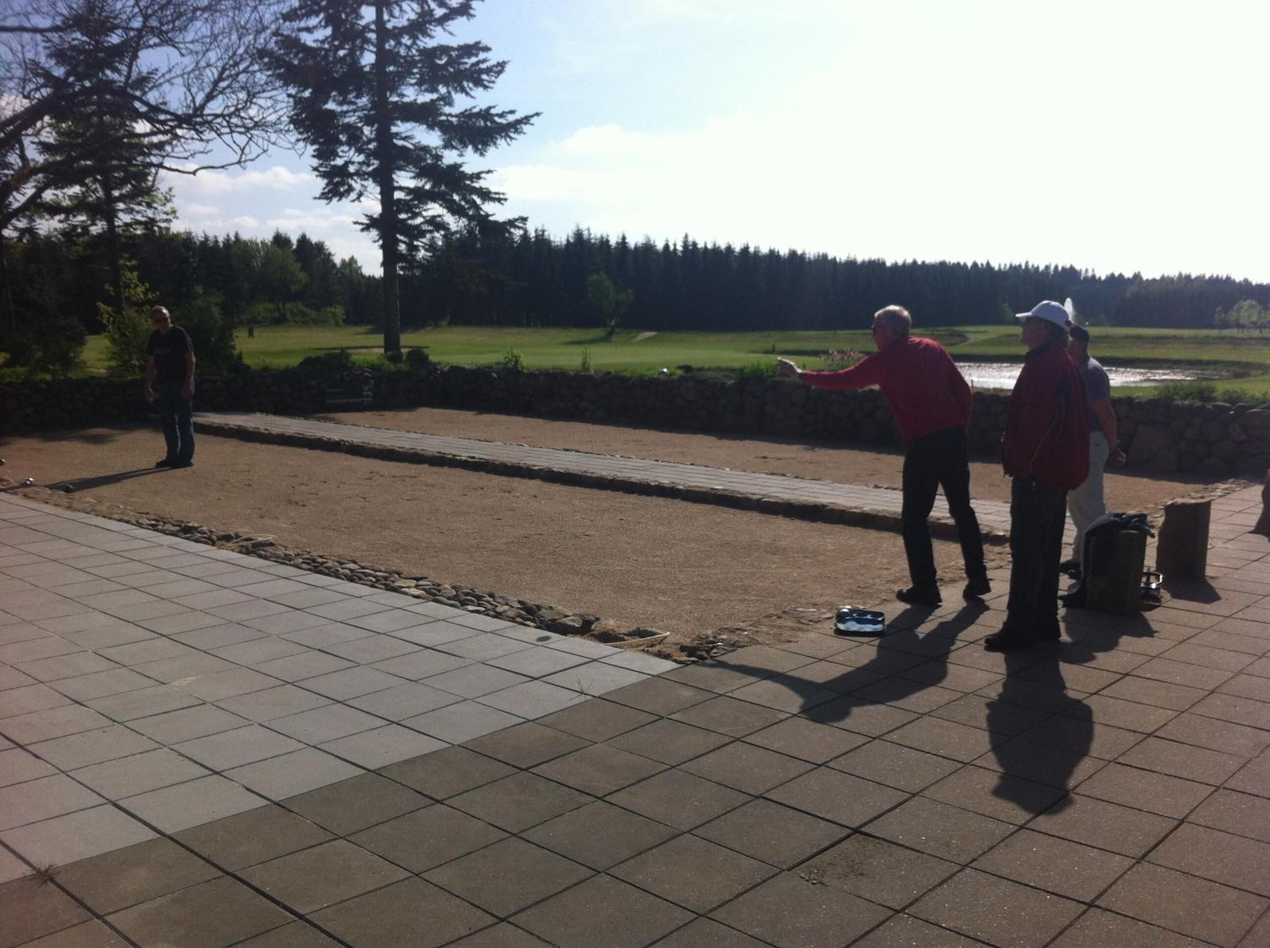A paved area with a long, narrow, open space, possibly for sports or activities.