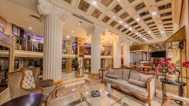 A spacious lobby with high ceilings, ornate columns, and a grand staircase. - Tilia Hotel (Istanbul)