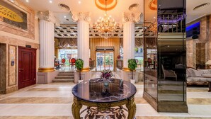 A grand lobby with a marble floor, a central round table with a vase of flowers, and a chandelier. - Tilia Hotel (Istanbul)