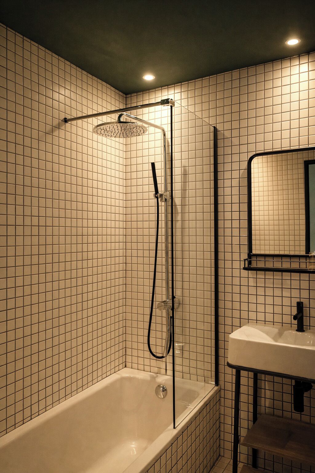 A bathroom with a walk-in shower, a bathtub, and a sink.