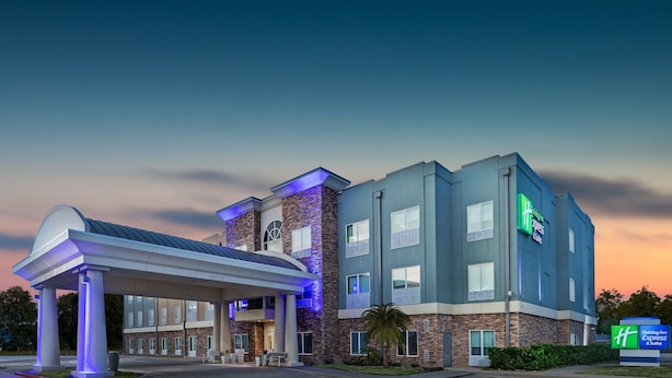 A Holiday Inn Express hotel with a modern design, featuring a covered outdoor area and a prominent sign. - Holiday Inn Express & Suites Rockport - Bay View by IHG (Rockport)