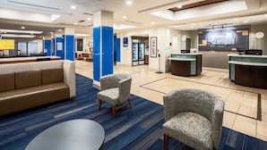 A spacious lobby with a reception desk, seating area, and a refrigerator. - Holiday Inn Express & Suites Rockport - Bay View by IHG (Rockport)