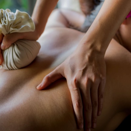 A close-up of a massage being performed on a person's back.