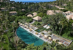 A resort with a large pool, multiple lounge areas, and a lush tropical setting. - Banyan Tree Samui (Koh Samui)