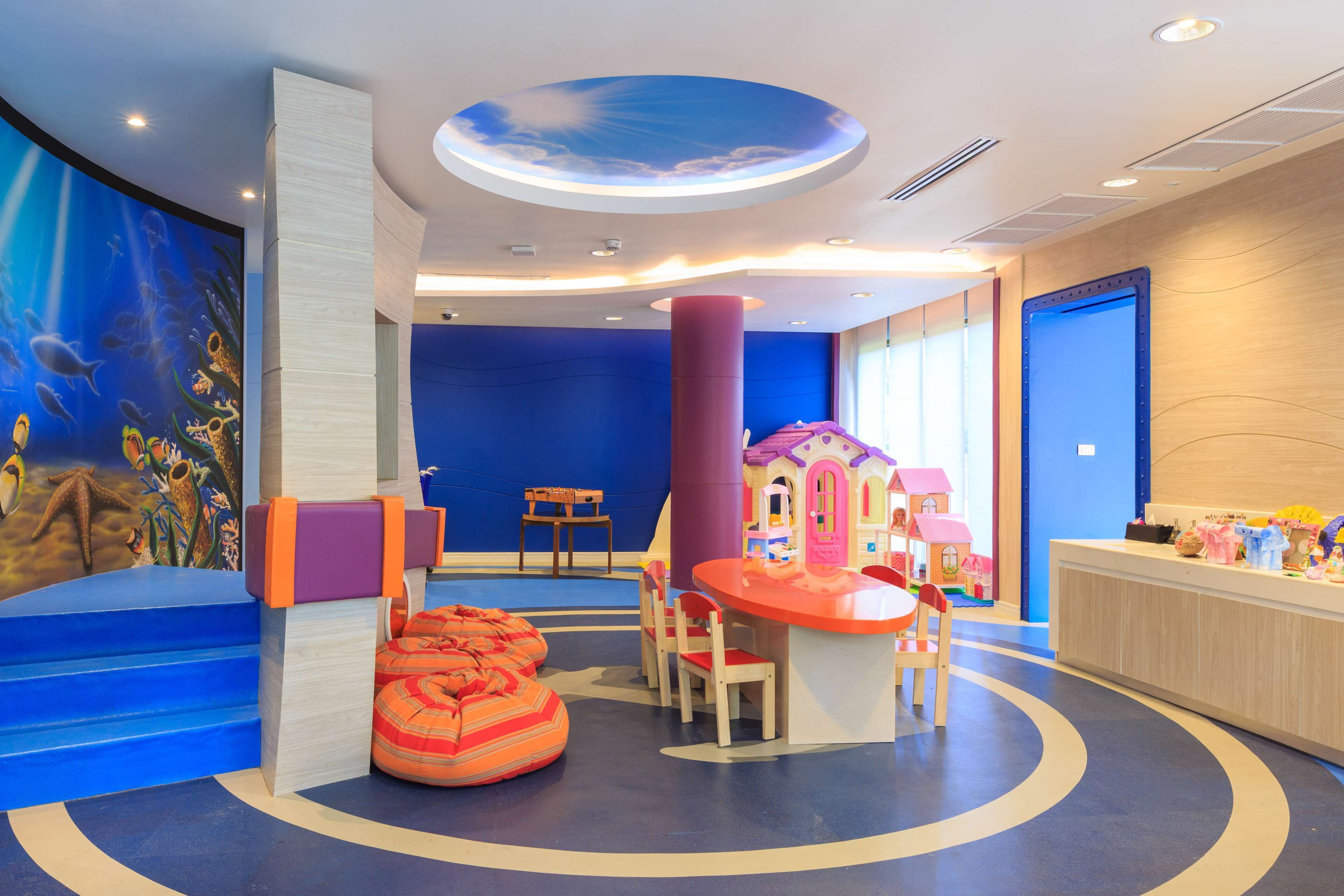 A children's play area with a slide, seating, and a playhouse.