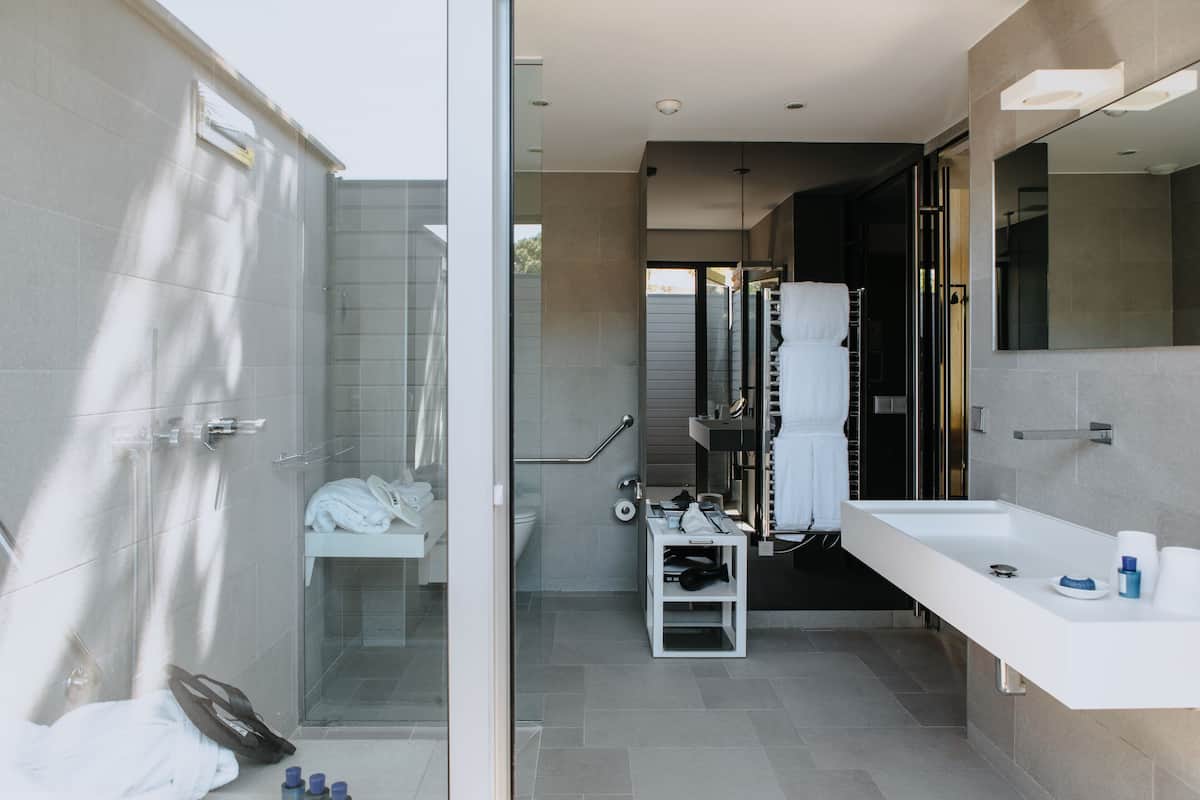 designer toiletries, hair dryer, bathrobes, slippers