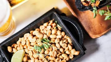 A variety of dishes including black bean salad, tacos, and a coleslaw side dish.