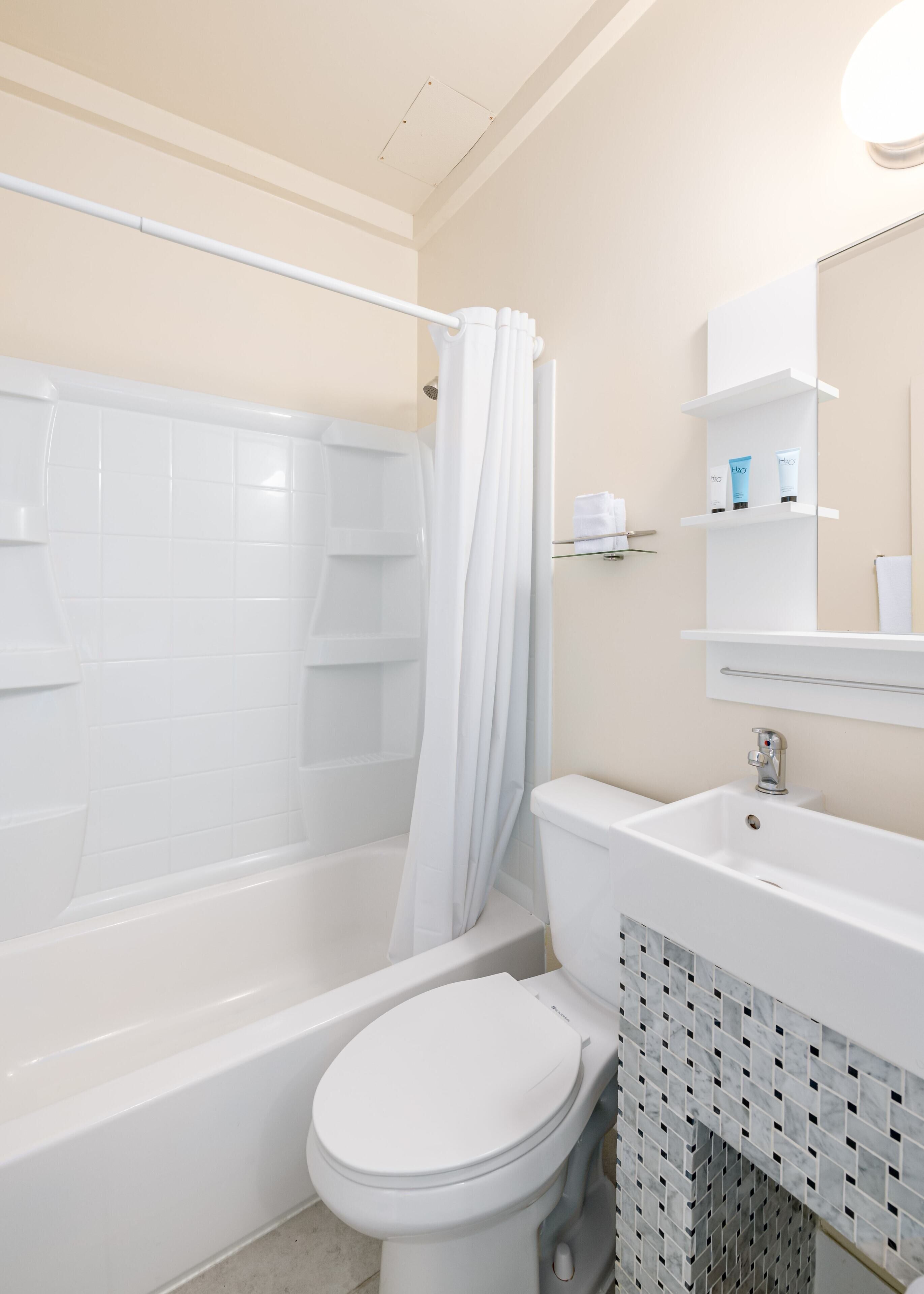 deluxe room, 2 queen beds | bathroom | combined shower/bathtub, free toiletries, hair dryer, towels