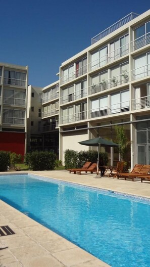 Piscina externa sazonal, funciona das 8h30 às 20h, guarda-sóis