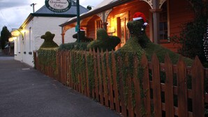 A building with a sign reading "Westbury Gingerbread Cottage B&B Cottages."