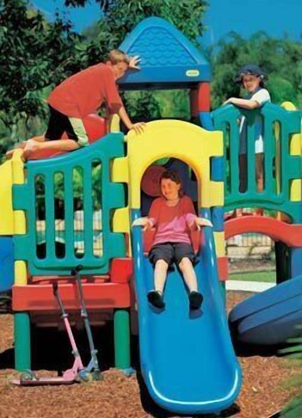 A playground with a slide and climbing structures.