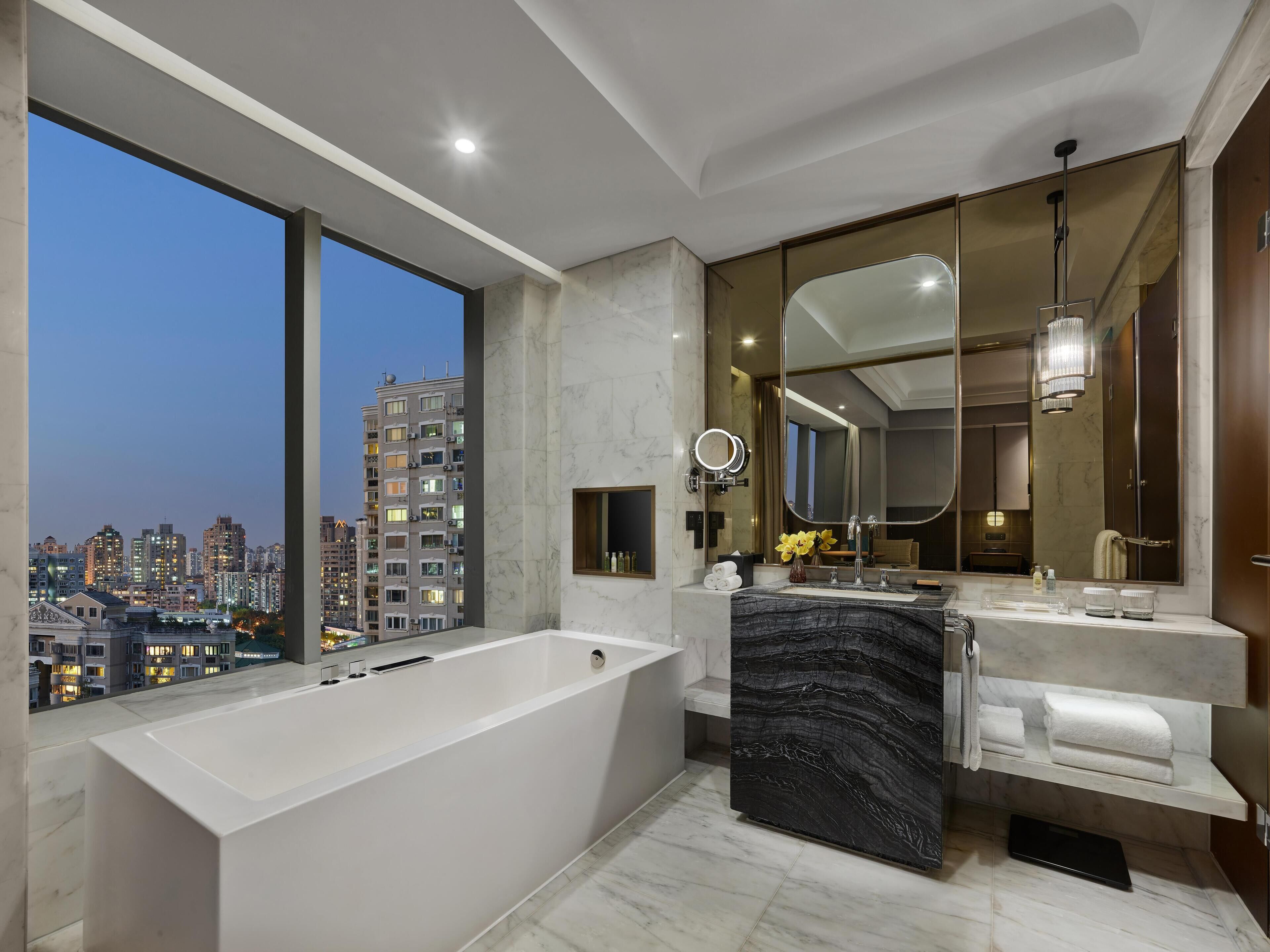 Premier Room, 1 King Bed | Bathroom | Separate bathtub and shower, rainfall showerhead, designer toiletries