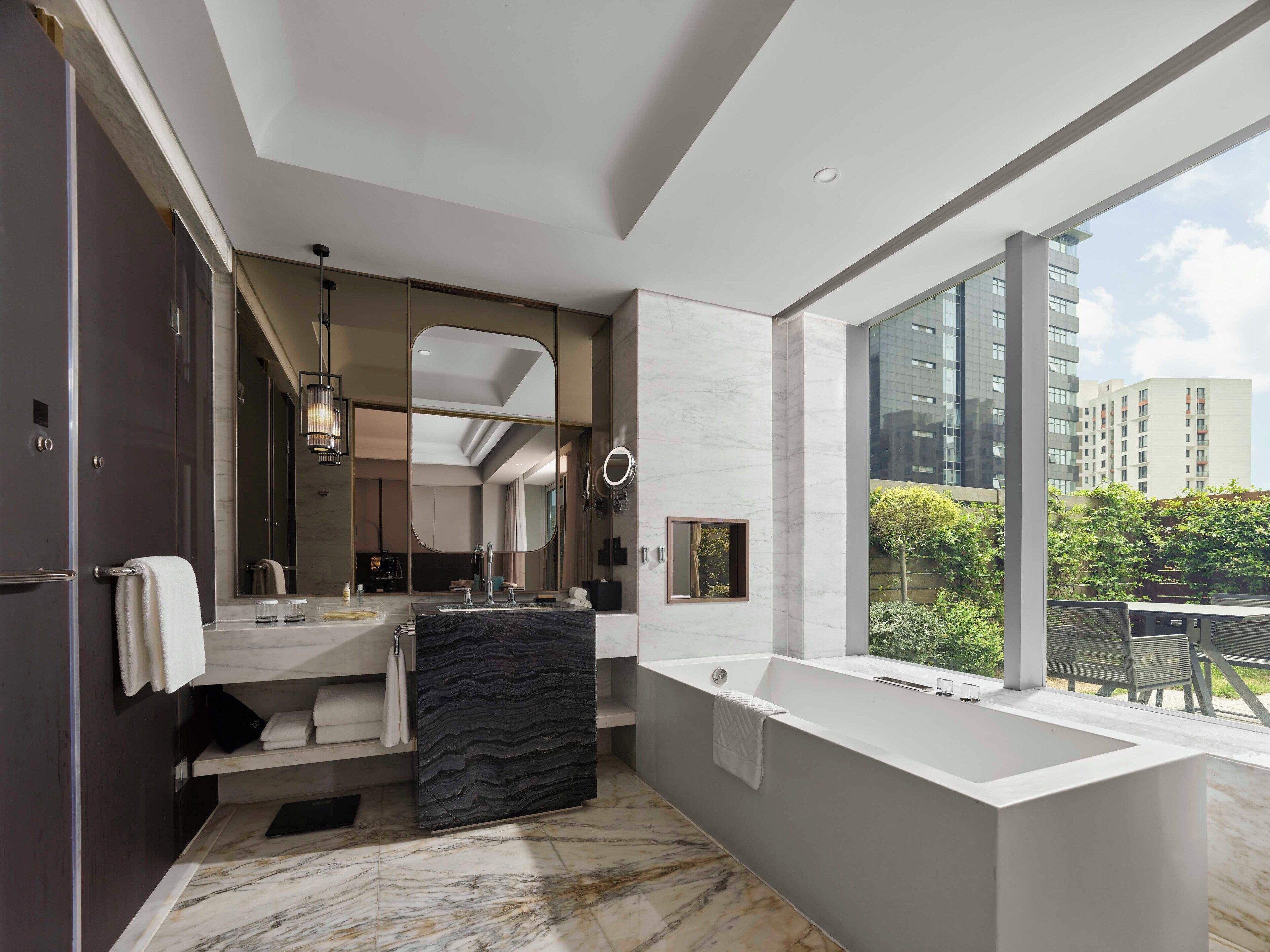 Separate tub and shower, rainfall showerhead, designer toiletries