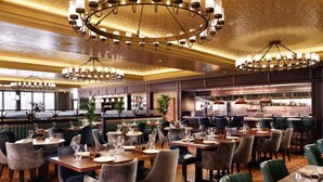 A restaurant with multiple dining tables and chairs, a bar area, and a kitchen in the background. - The Grand, York (York)