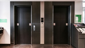 A modern elevator with a digital display, two doors, and a control panel on the right. - Vessel Inn Hakata Nakasu (Fukuoka)
