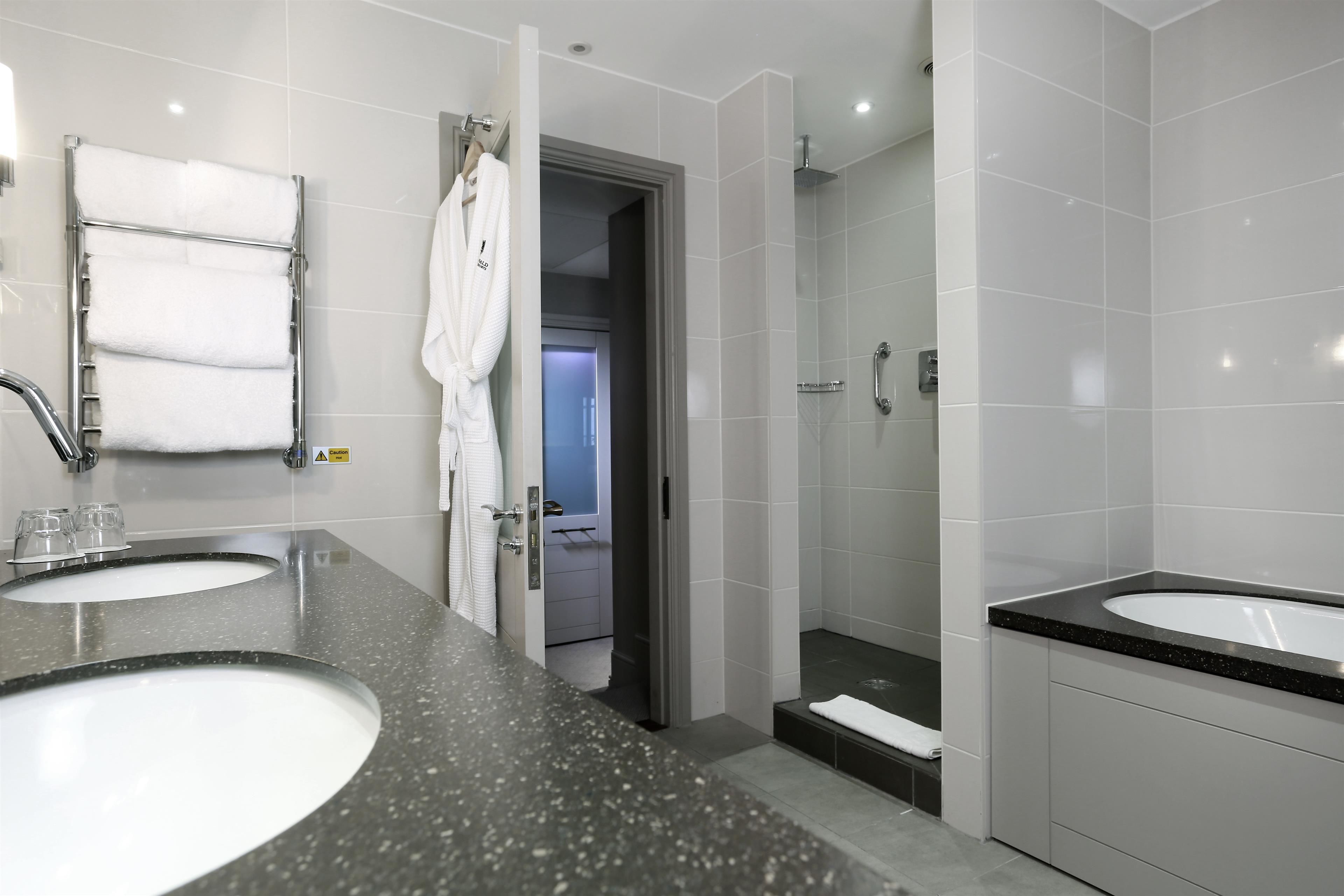 designer toiletries, hair dryer, slippers, towels