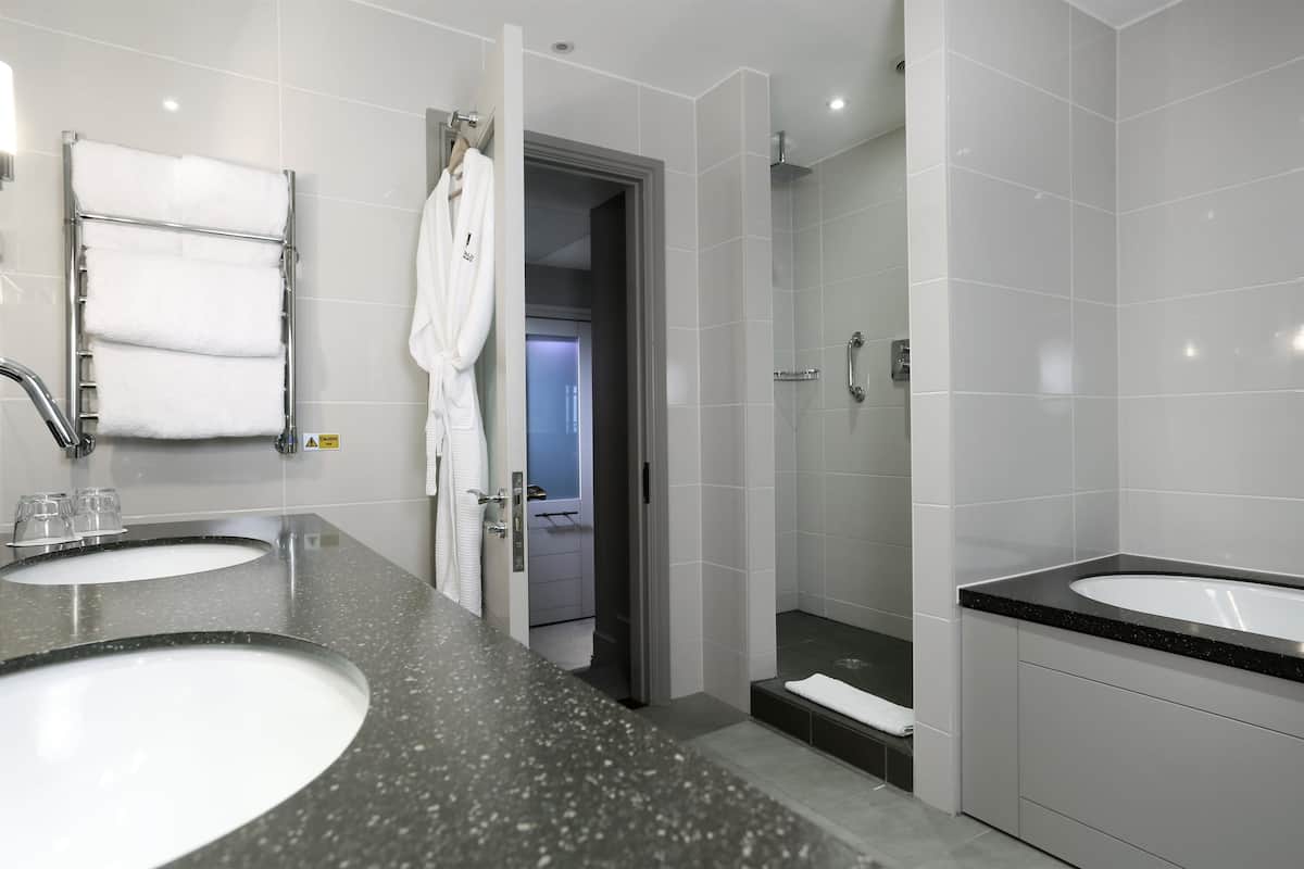 designer toiletries, hair dryer, slippers, towels