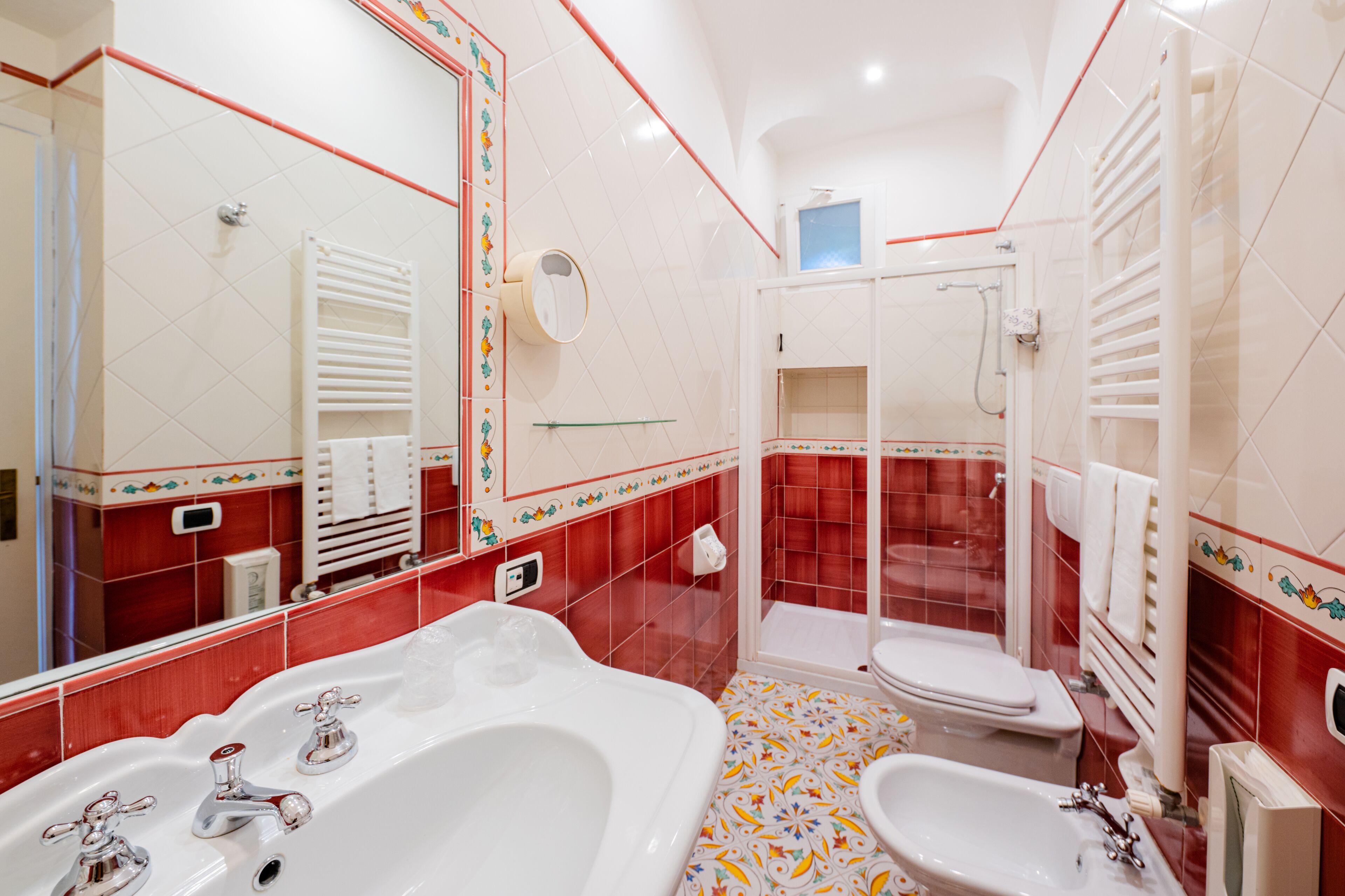 A bathroom with a large bathtub, a separate shower area, and a sink.