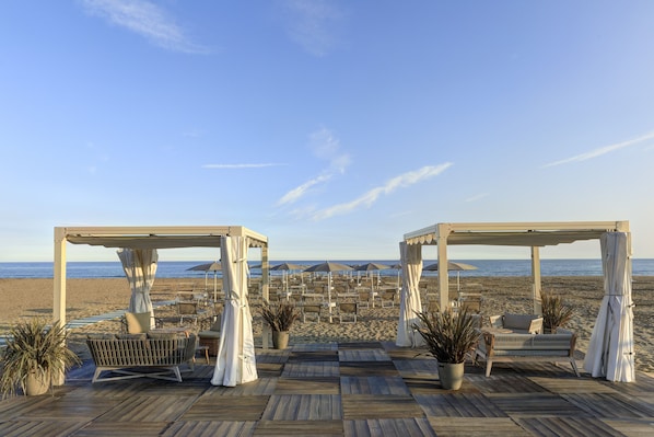 On the beach, sun loungers, beach umbrellas