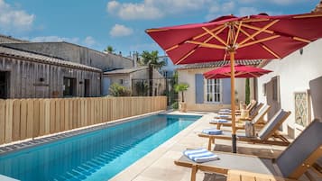 Seasonal outdoor pool, open 11:00 AM to 7:00 PM, pool umbrellas