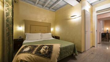 Ein Hotelzimmer mit Bett, Nachttisch und Wandleuchte.