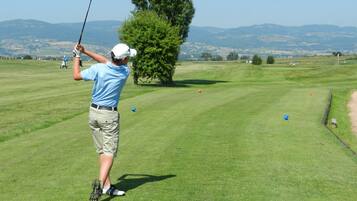 Enjoy a round of golf amidst rolling hills and a distant mountain range.