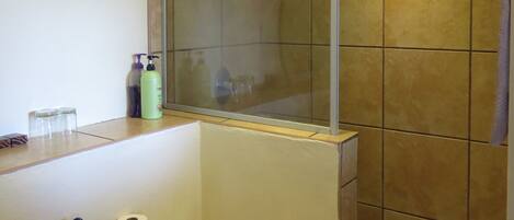 A bathroom with a shower, toilet, and sink.