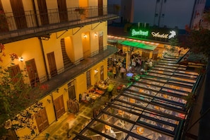 A multi-level outdoor dining area with a restaurant named 'Pilsner Urquell' and 'Andel' on the ground floor. - Andelapartments (Prague)