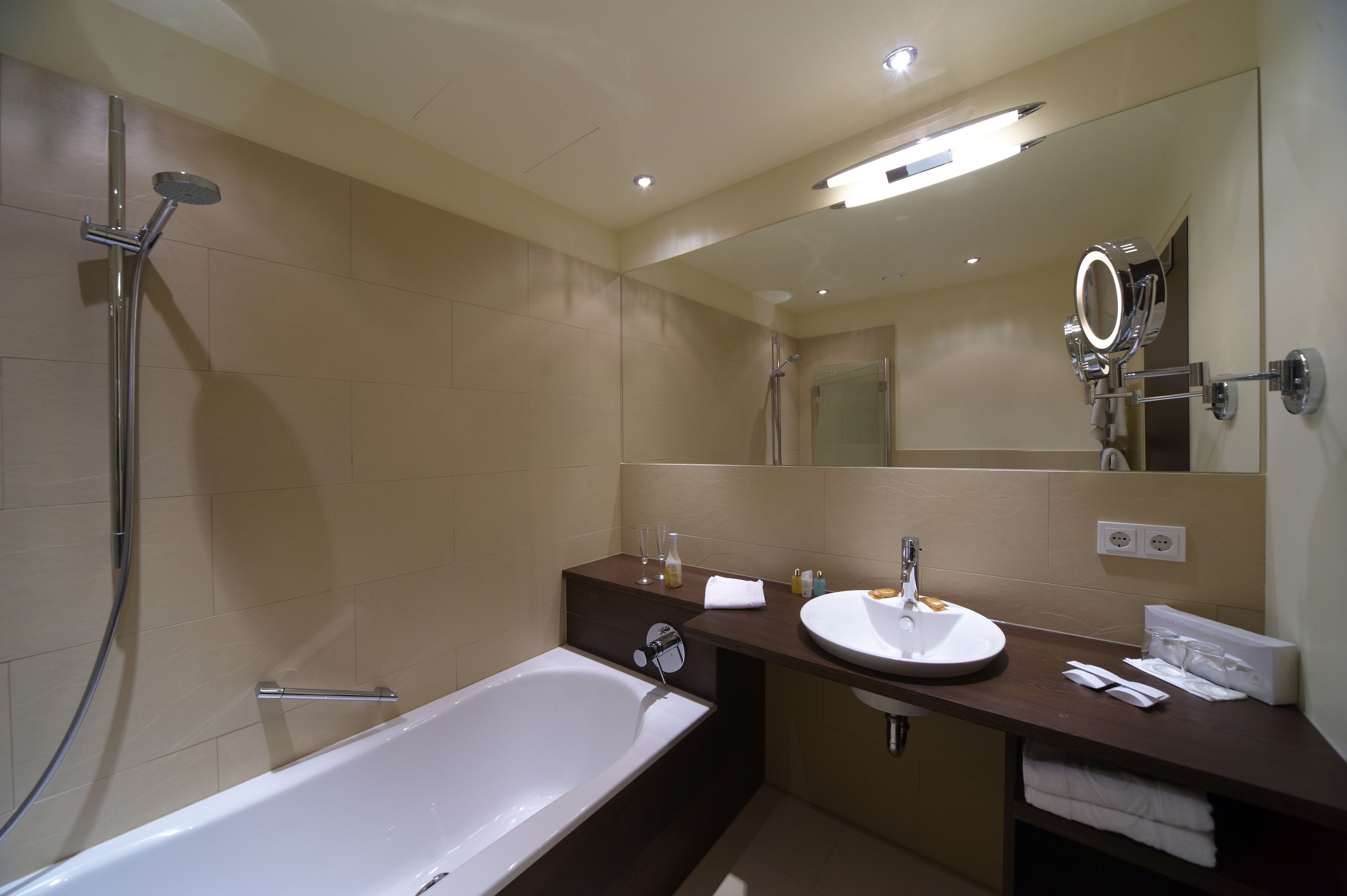 A modern bathroom with a bathtub, a sink, and a shower.